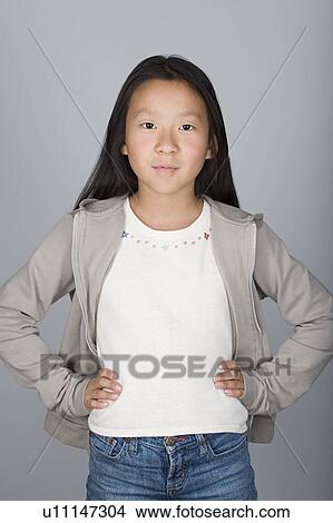 Studio portrait of confident Chinese teenage girl (16-17) View Large Photo Image Picture - Studio portrait of confident Chinese teenage girl (16-17). Fotosearch
