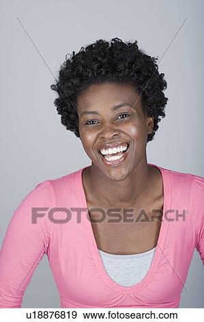 Stock Photo - Studio portrait of happy mid adult woman. Fotosearch