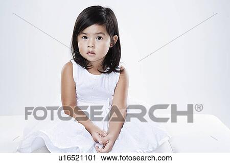 Stock Image - Studio portrait of little girl. Fotosearch