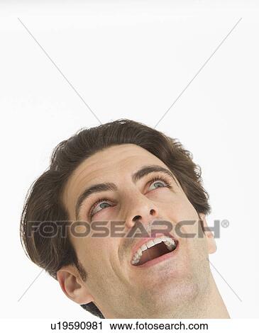 Studio portrait of man smiling and looking up View Large Photo Image Stock Image - Studio portrait of man smiling and looking up. Fotosearch