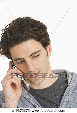 Studio portrait of man talking on mobile phone View Large Photo Image Stock Image - Studio portrait of man talking on mobile phone. Fotosearch