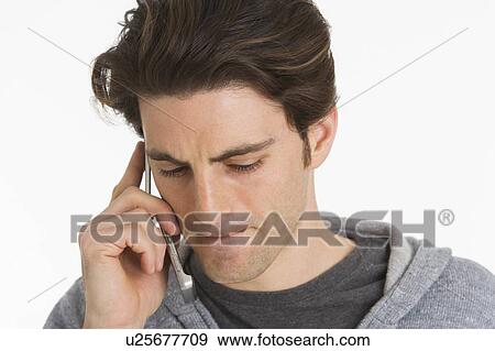 Studio portrait of man talking on mobile phone View Large Photo Image Stock Photo - Studio portrait of man talking on mobile phone. Fotosearch