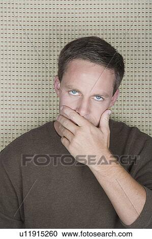 Studio portrait of mature man covering mouth with hand View Large Photo Image Stock Image - Studio portrait of mature man covering mouth with hand. Fotosearch