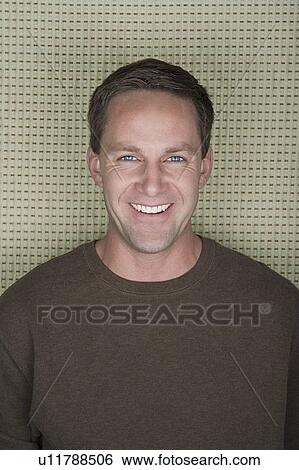 Stock Photograph - Studio portrait of mature man smiling. Fotosearch