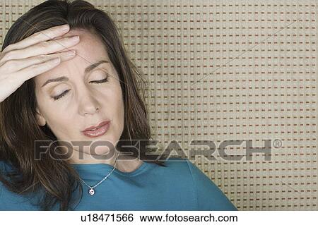 Studio portrait of mature woman with hand on forehead View Large Photo Image Stock Photograph - Studio portrait of mature woman with hand on forehead. Fotosearch