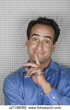 Stock Image - Studio portrait of mid adult man smiling. Fotosearch