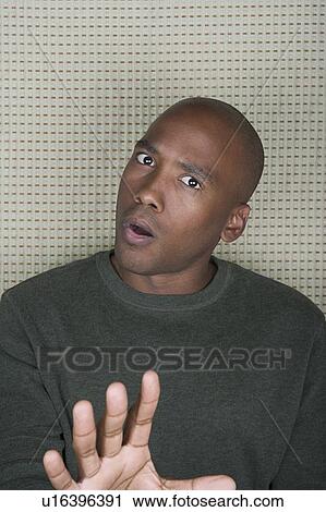 Studio portrait of mid adult man gesturing View Large Photo Image Stock Image - Studio portrait of mid adult man gesturing. Fotosearch