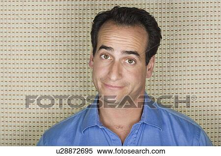 Stock Photography - Studio portrait of mid adult man. Fotosearch