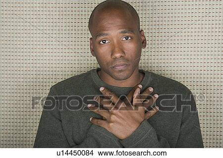 Picture - Studio portrait of mid adult man with hands folded on chest. Fotosearch