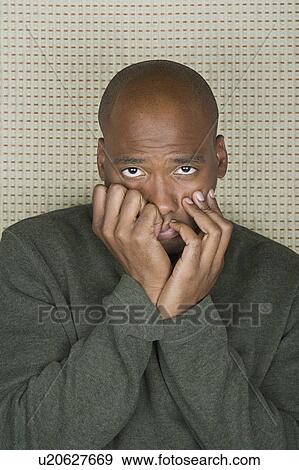 Studio portrait of mid adult man with head in hands View Large Photo Image Stock Photo - Studio portrait of mid adult man with head in hands. Fotosearch