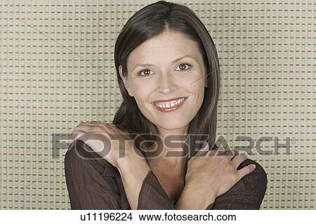 Studio portrait of mid adult woman smiling View Large Photo Image Picture - Studio portrait of mid adult woman smiling. Fotosearch