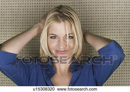 Stock Image - Studio portrait of mid adult woman smiling. Fotosearch