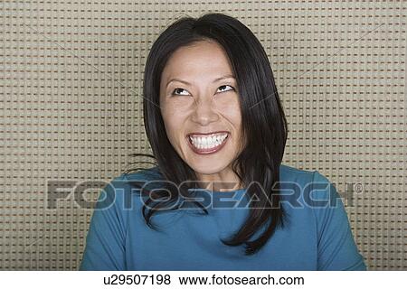 Studio portrait of mid adult woman laughing View Large Photo Image Stock Photo - Studio portrait of mid adult woman laughing. Fotosearch