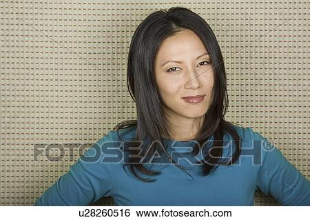 Stock Photograph - Studio portrait of mid adult woman. Fotosearch