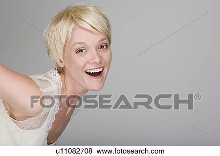 Studio portrait of playful young woman View Large Photo Image Stock Photo - Studio portrait of playful young woman. Fotosearch