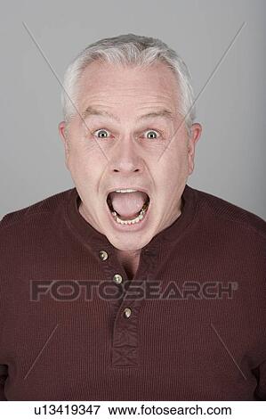 Stock Photo - Studio portrait of scared senior man. Fotosearch