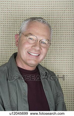 Stock Photo - Studio portrait of senior man smiling. Fotosearch