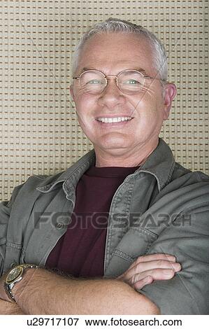 Studio portrait of senior man smiling View Large Photo Image Stock Photo - Studio portrait of senior man smiling. Fotosearch
