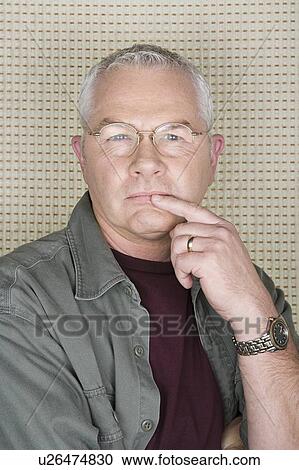 Stock Image - Studio portrait of senior man. Fotosearch