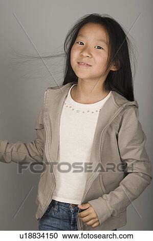 Stock Image - Studio portrait of teen (16-17) girl. Fotosearch