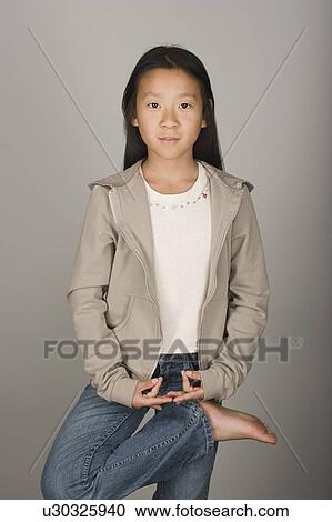 Studio portrait of teen (16-17) girl standing on one leg View Large Photo Image Stock Image - Studio portrait of teen (16-17) girl standing on one leg. Fotosearch