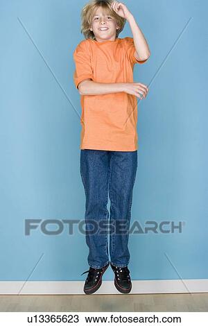 Studio portrait of teenage (16-17) boy jumping View Large Photo Image Stock Image - Studio portrait of teenage (16-17) boy jumping. Fotosearch