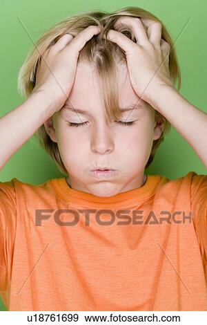 Studio portrait of teenage (16-17) boy with head in hands View Large Photo Image Stock Photo - Studio portrait of teenage (16-17) boy with head in hands. Fotosearch
