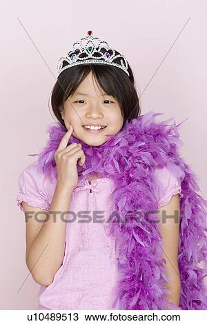 Studio portrait of teenage (16-17) girl wearing tiara and feather boa View Large Photo Image Stock Image - Studio portrait of teenage (16-17) girl wearing tiara and feather boa. Fotosearch