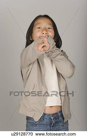 Stock Image - Studio portrait of teenage (16-17) girl. Fotosearch