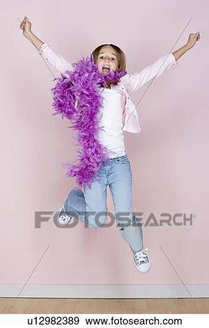 Studio portrait of teenage (16-17) girl jumping View Large Photo Image Stock Photo - Studio portrait of teenage (16-17) girl jumping. Fotosearch