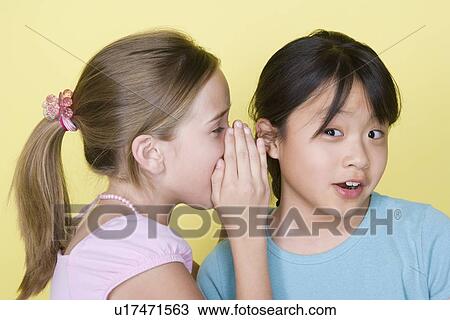 Studio portrait of teenage (16-17) girls gossiping View Large Photo Image Stock Image - Studio portrait of teenage (16-17) girls gossiping. Fotosearch