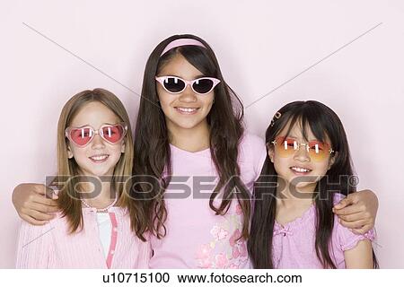 Studio portrait of three teenage (16-17) girls wearing sunglasses View Large Photo Image Stock Image - Studio portrait of three teenage (16-17) girls wearing sunglasses. Fotosearch