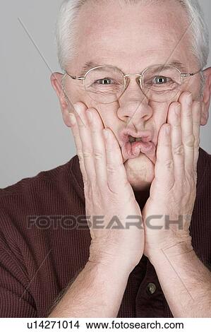 Picture - Studio portrait of worried senior man. Fotosearch