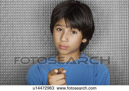 Studio portrait of young man pointing at camera View Large Photo Image Stock Image - Studio portrait of young man pointing at camera. Fotosearch