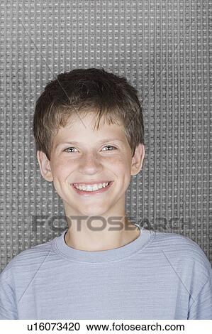Stock Image - Studio portrait of young man smiling. Fotosearch