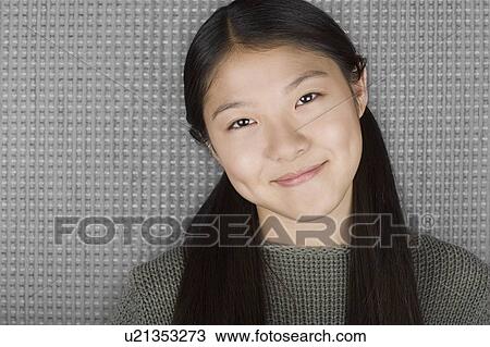 Studio portrait of young woman smiling View Large Photo Image Stock Image - Studio portrait of young woman smiling. Fotosearch