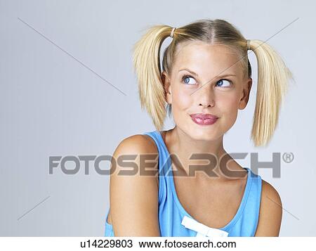 Stock Image - Studio portrait of young woman. Fotosearch