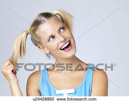 Stock Image - Studio portrait of young woman. Fotosearch