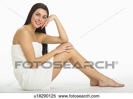 Stock Photography - Studio portrait of young woman wrapped in towel. Fotosearch