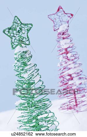 Stock Image - Studio shot of artificial Christmas trees. Fotosearch