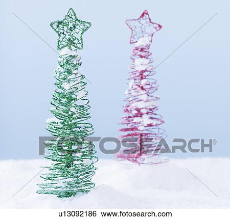 Stock Photograph - Studio shot of artificial Christmas trees. Fotosearch