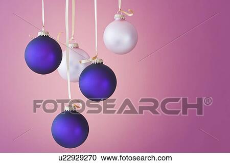 Stock Image - Studio shot of blue and white Christmas ornaments. Fotosearch