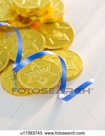 Studio Shot of chocolate coin and blue ribbon View Large Photo Image Stock Image - Studio Shot of chocolate coin and blue ribbon. Fotosearch
