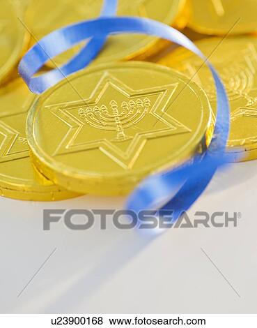 Studio Shot of chocolate coin and blue ribbon View Large Photo Image Stock Photo - Studio Shot of chocolate coin and blue ribbon. Fotosearch