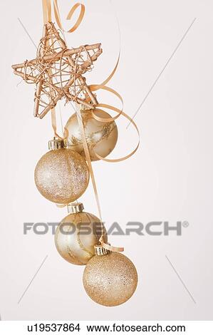 Picture - Studio shot of gold Christmas ornaments. Fotosearch