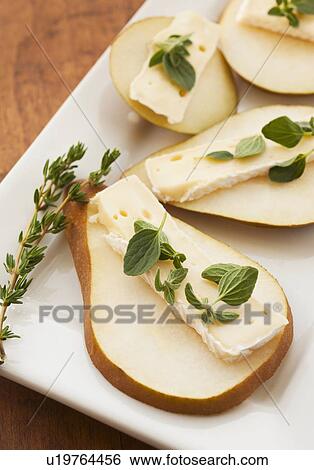Studio shot of sliced pear with herbs View Large Photo Image Stock Photograph - Studio shot of sliced pear with herbs. Fotosearch
