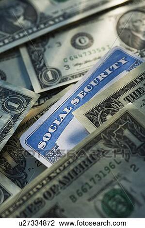 Stock Image - Studio shot of social security card and banknotes. Fotosearch