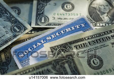 Stock Photograph - Studio shot of social security card and banknotes. Fotosearch