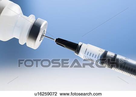 Stock Image - Studio shot of syringe and vial. Fotosearch