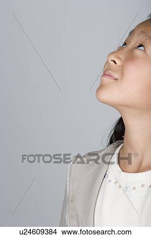 Studio shot of teenage girl looking up, part of View Large Photo Image Picture - Studio shot of teenage girl looking up, part of. Fotosearch
